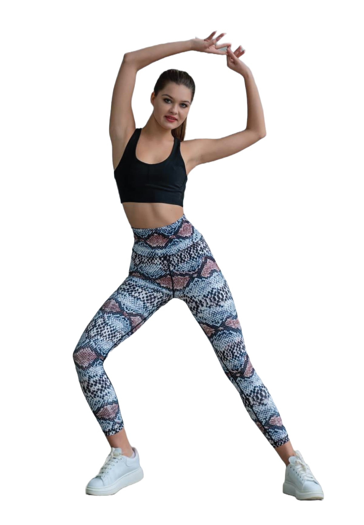 Person posiert in Lisminas 328 Extra High Waist Leggings in Braun & Blau, trägt Turnschuhe und hat die Arme anmutig erhoben.